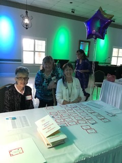 Library staff Shirley Pagliaro and Miriam Thompson, ready to receive Luncheon guests with programs and name tags